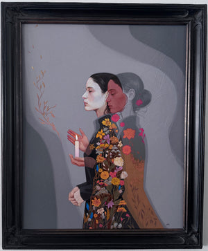 A framed painting featuring a stylized illustration of two women in profile against a gray background, with one woman in a floral-patterned dress and the other in a brown dress. The artwork is housed in a black ornate frame and hangs on a light gray wall.