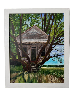 Framed artwork of a tree house in a natural setting