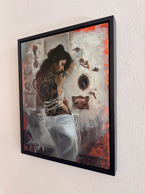 Framed artwork of a woman with tattoos sitting in a room with decorative elements.