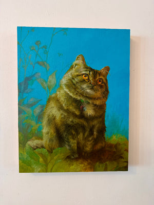 Painting of a cat sitting on grass with a blue background