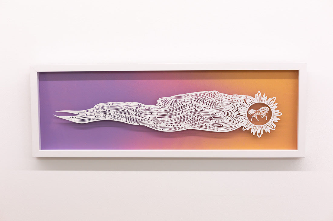 Framed artwork with a white abstract design on a gradient purple to orange background