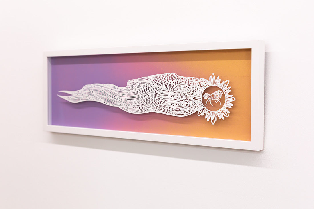 Framed artwork with a white abstract design on a gradient purple to orange background