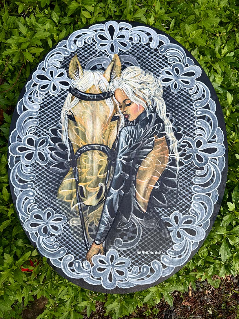 Oval painting with a woman and horse illustration on a wooden background