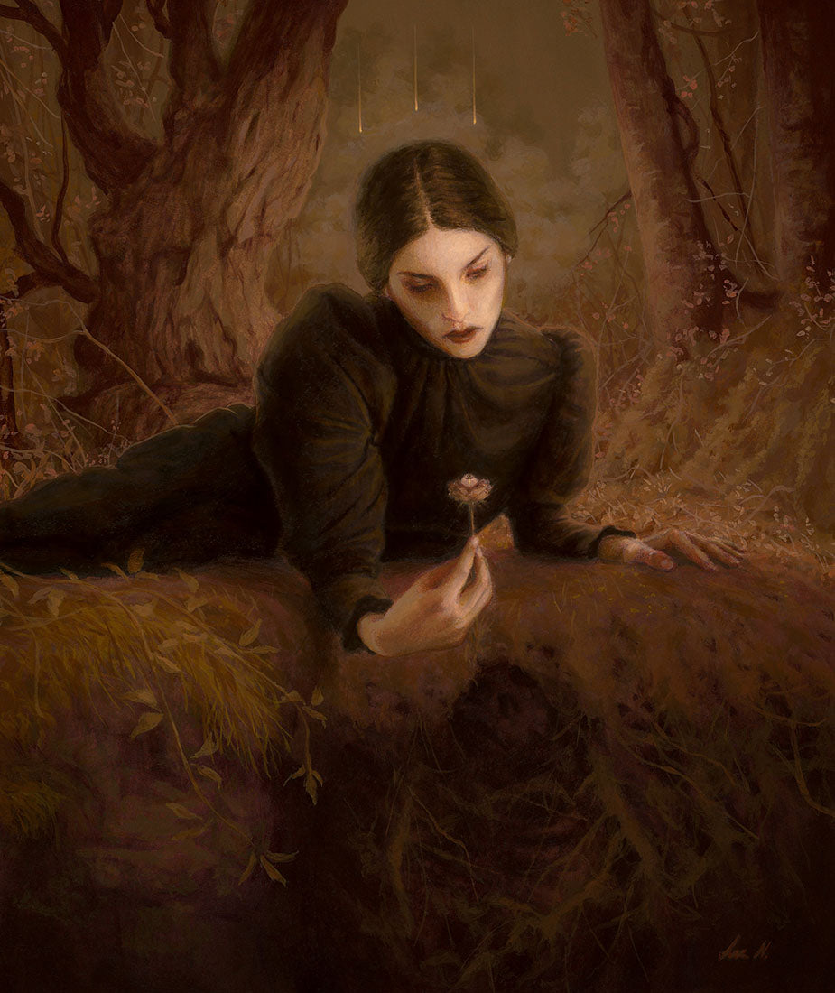 Woman in a dark coat sitting in a forest, holding a flower.