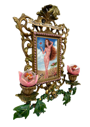 Decorative wall piece with a framed artwork of a nude figure, surrounded by ornate gold frame and floral elements.