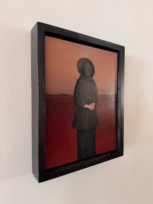 Framed artwork of a person with a red background