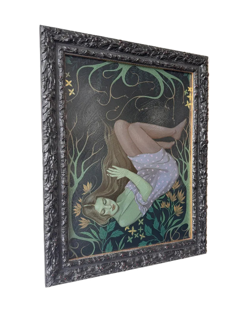 Framed artwork of a woman with long hair and flowers on a dark background