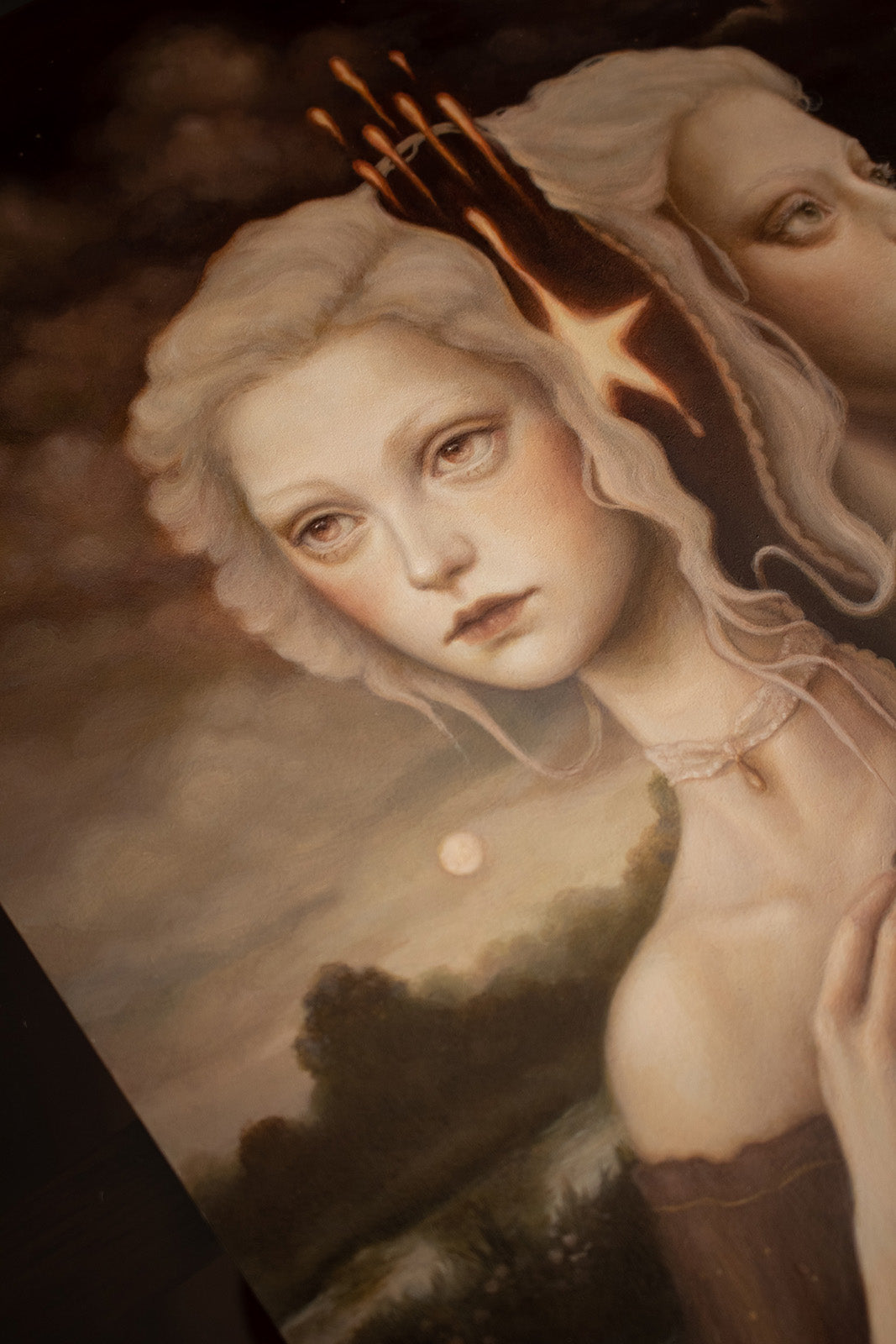 detail of an oil painting showing two female faces and a moon in the background.