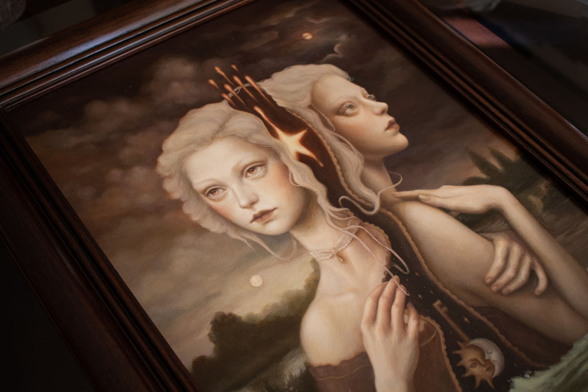 45 degree angle view of a Surreal painting in brown tones of two women entwined by their hair representing night and day while up to their belly in crashing waves.