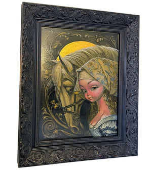 Framed artwork of a woman and horse with intricate details on a beige wall.