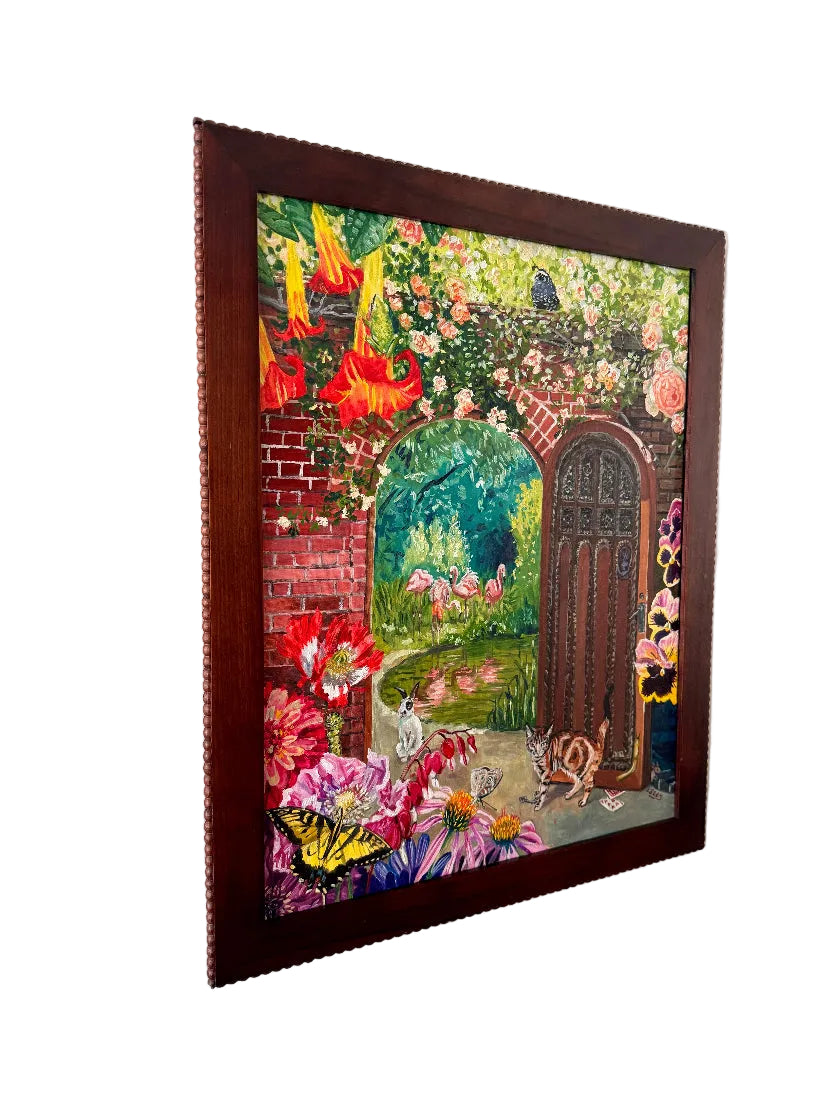 Framed artwork of a garden scene with flowers and a door on a wall.