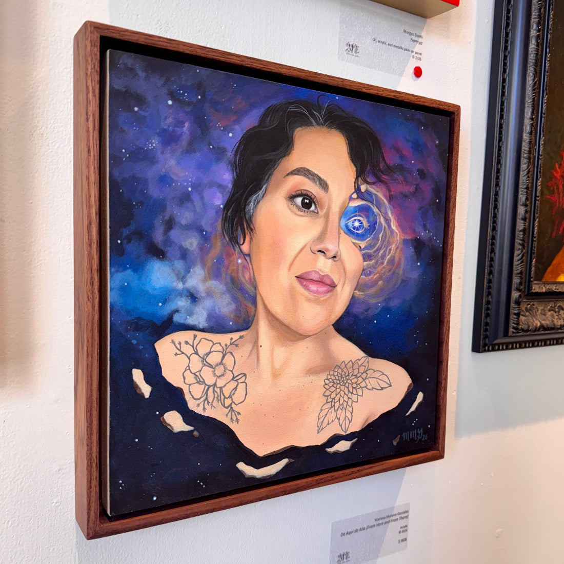 Framed artwork of a woman with a cosmic background