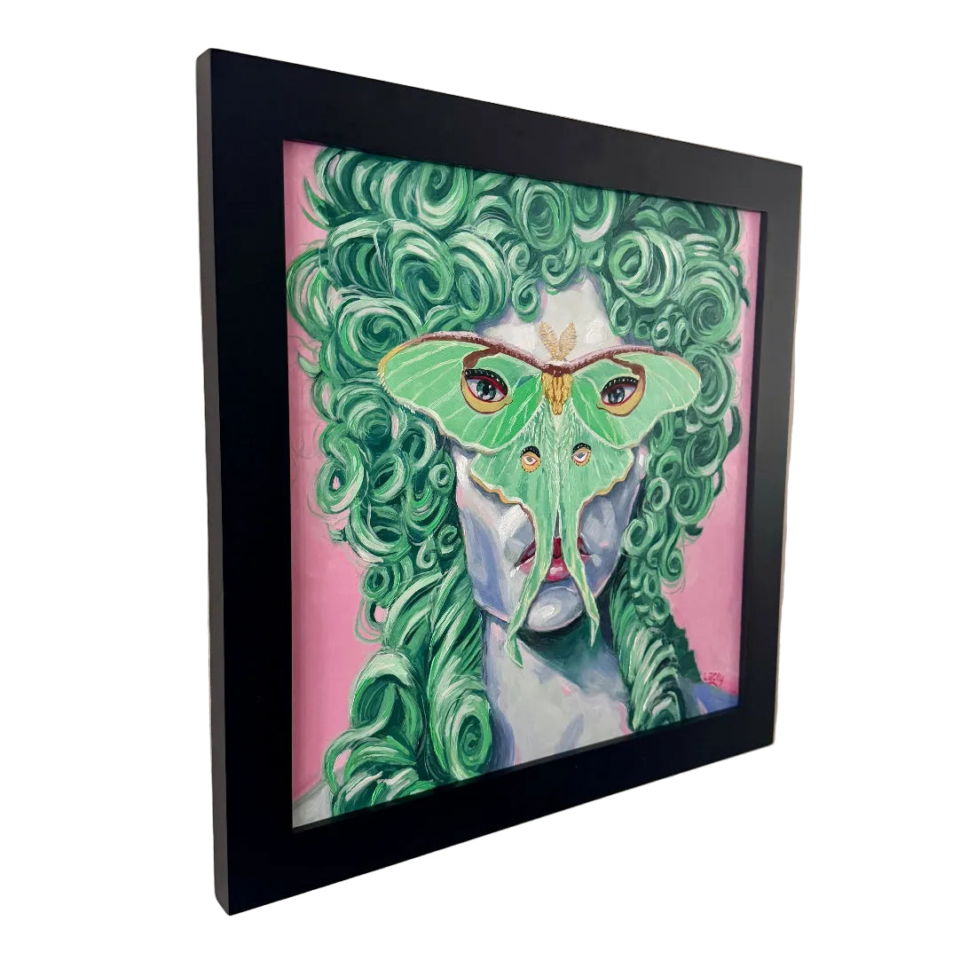 Framed artwork of a person with green hair and a butterfly on their face against a pink background.