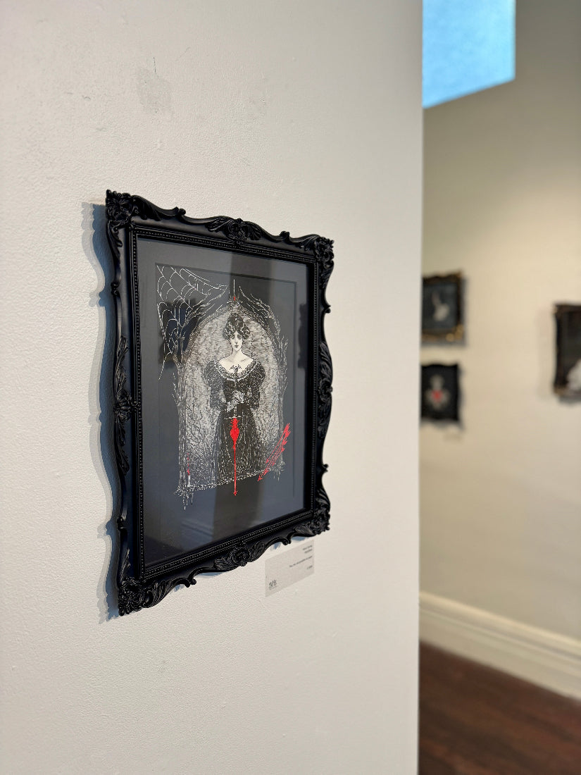 Framed artwork on a wall in an art gallery setting
