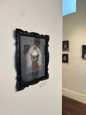 Framed artwork on a wall in an art gallery setting