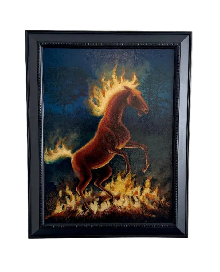 Framed artwork of a horse with flames on a white wall