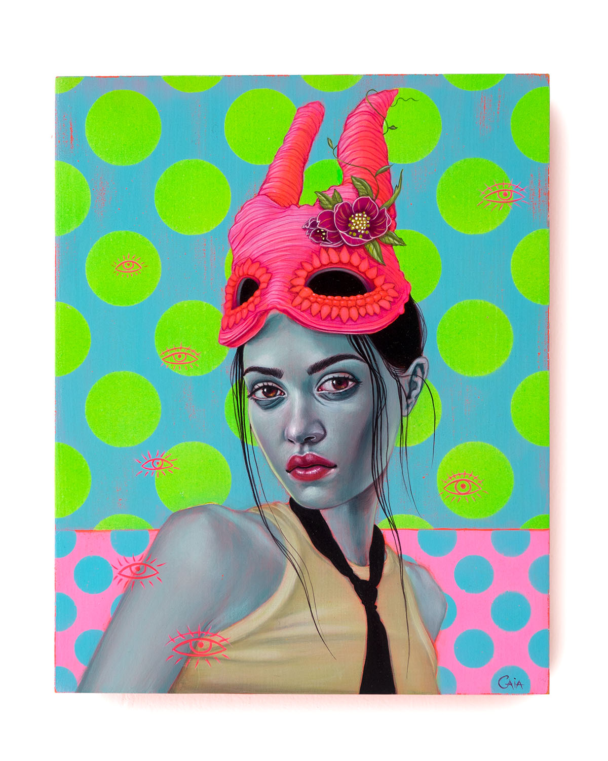 Panel on wall shot of fluorescent color portrait of a woman wearing a pink horned mask and a black tie and sleeveless top in front of a background of green spots on blue and blue spots on pink and scattered red eye outline symbols.
