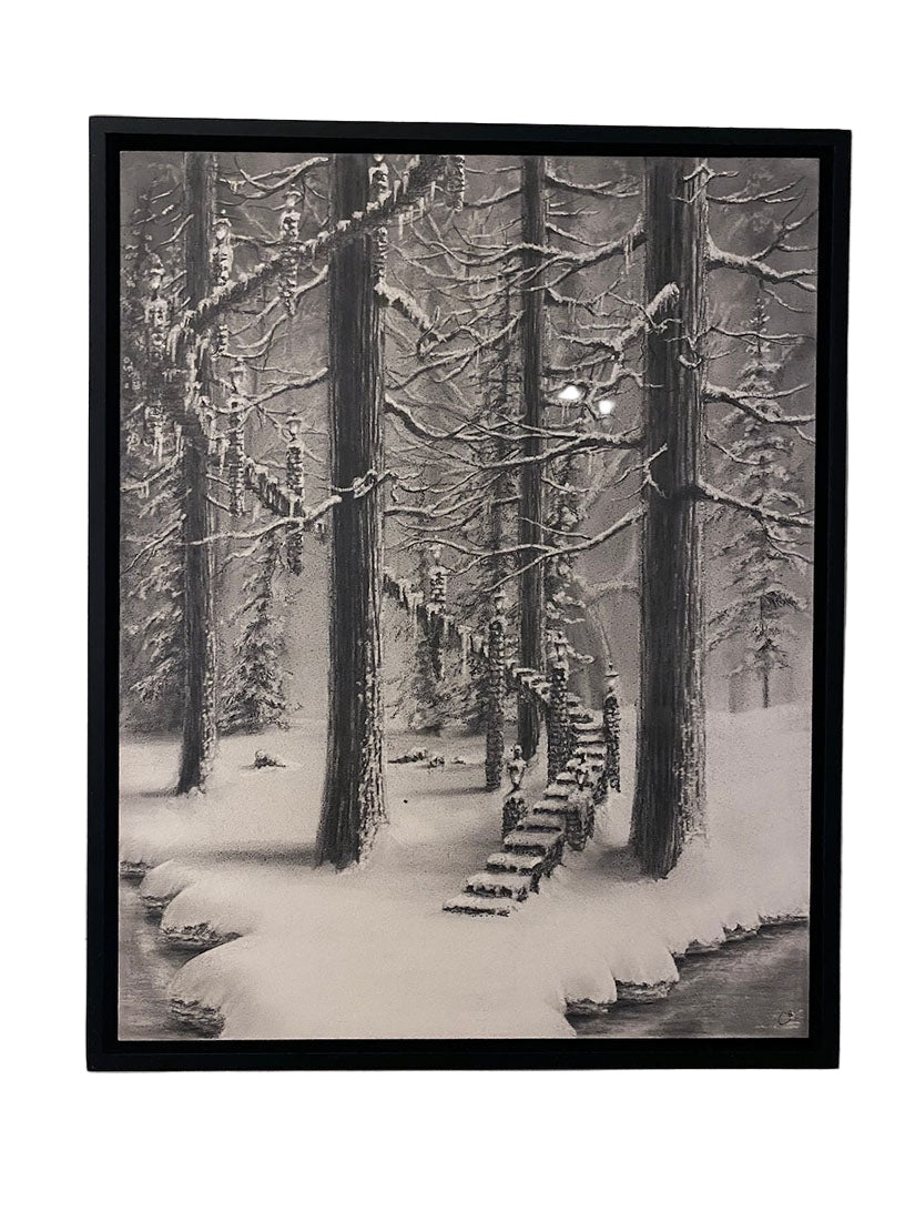 Framed artwork of a snowy forest scene with trees and footprints in the snow.