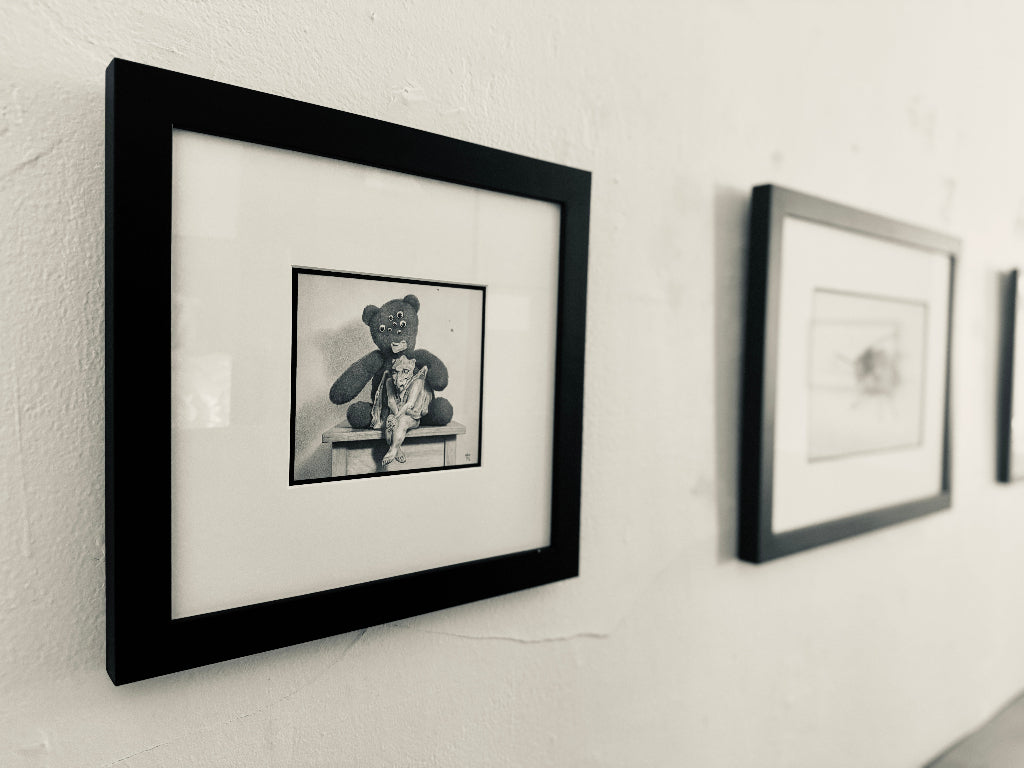 Framed black and white artwork on a wall