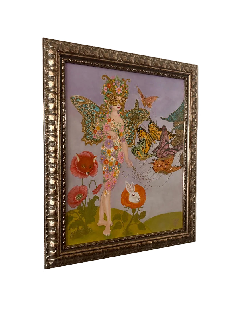 Framed artwork of a fairy with butterflies and flowers on a white wall