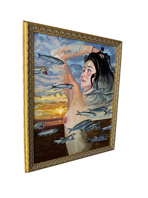 Framed artwork of a woman with fish around her on a plain wall.