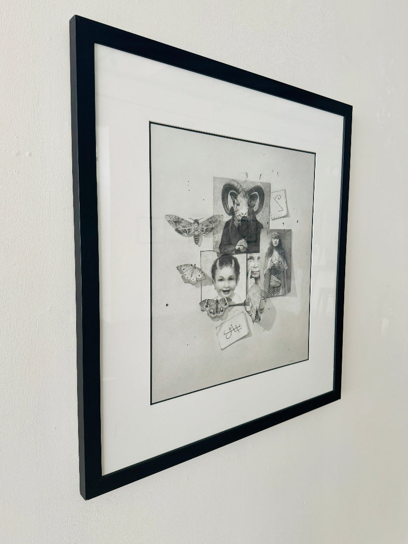 Framed black and white drawing on a wall