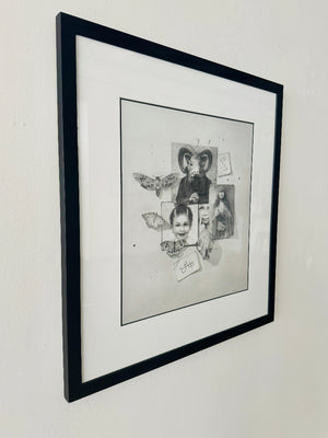 Framed black and white drawing on a wall