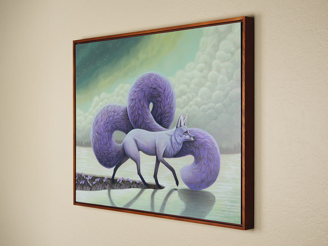 Framed artwork of a purple fox with a green landscape background on a beige wall.