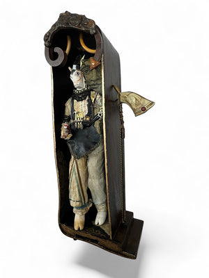 Detailed figurine of a character in a decorative case on a white background