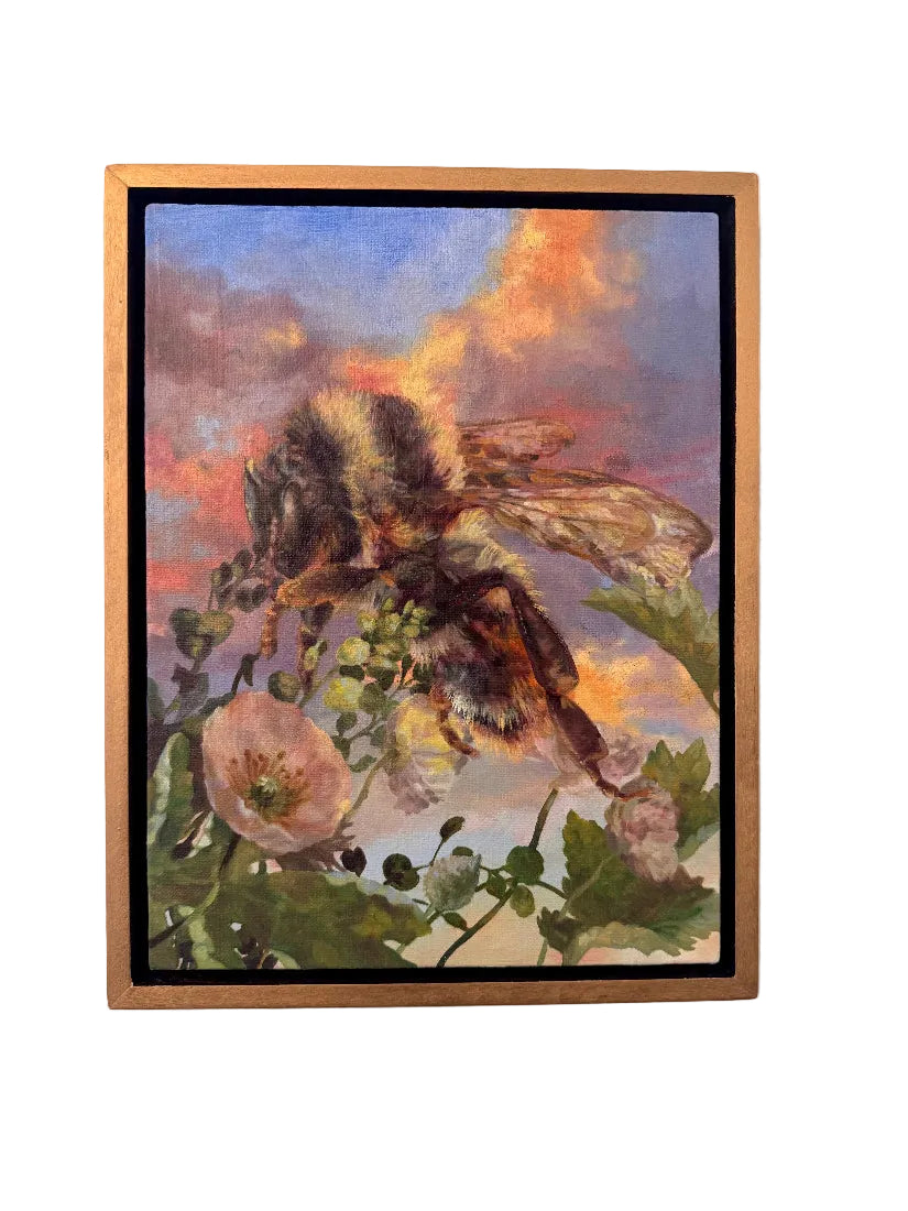 Framed artwork of a bee on a flower with a colorful sky background