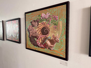 Framed artwork of a fantasy creature with floral elements on a white wall.