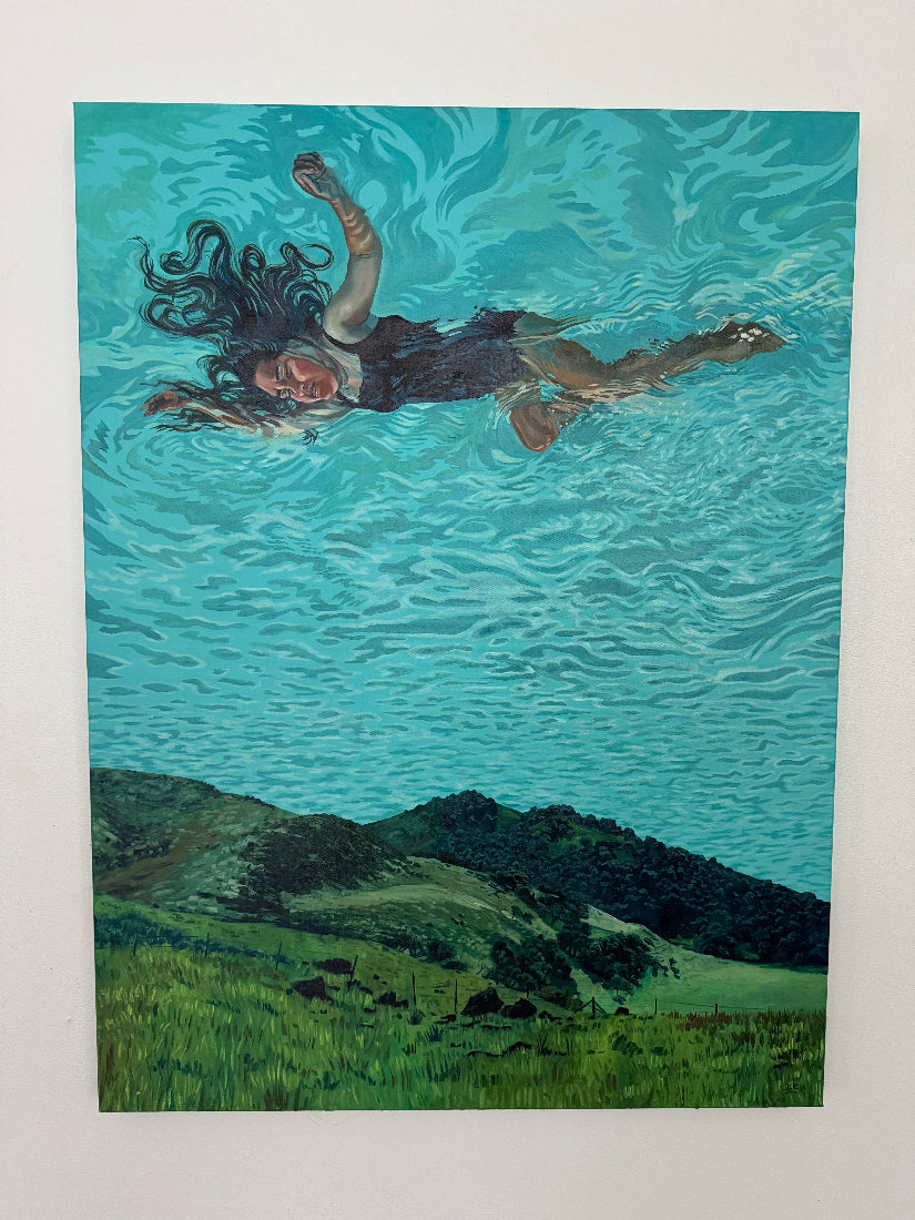 Woman floating on water with a landscape in the background
