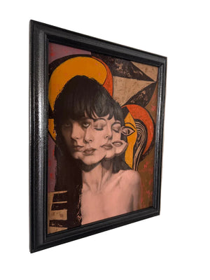 Framed artwork of a stylized portrait on a beige wall