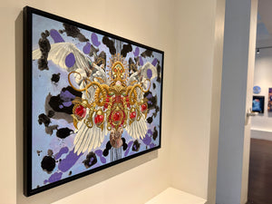 Framed artwork with butterfly design on a wall in an art gallery.