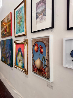 Art gallery wall with various framed paintings