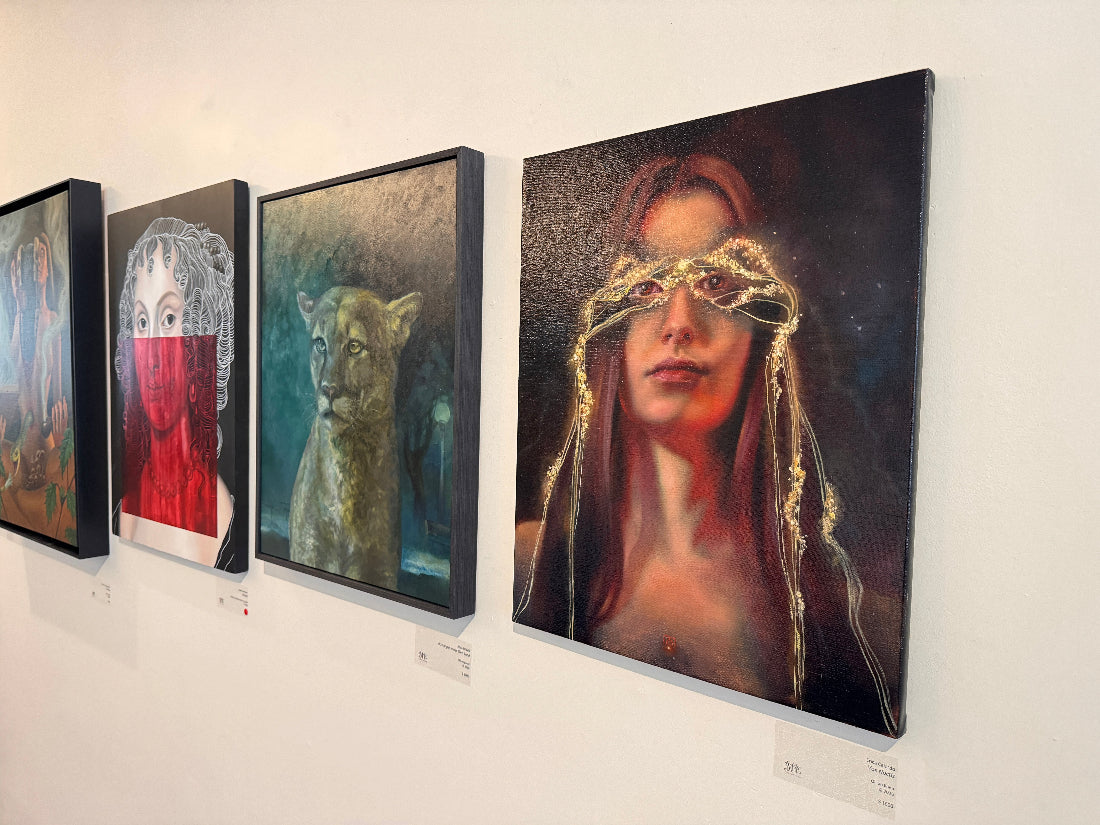 Art gallery with various paintings on a wall