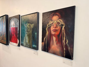 Art gallery with various paintings on a wall