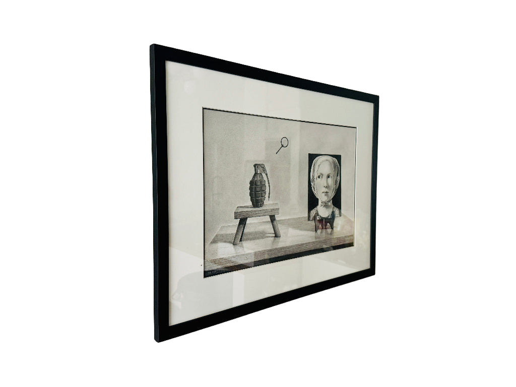 Framed black and white drawing on a wall