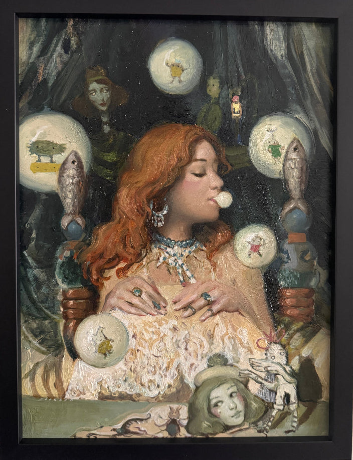 Framed artwork of a woman with red hair holding crystal balls against a dark background.