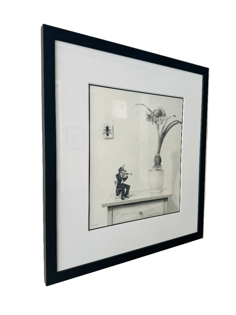 Framed black and white drawing on a wall