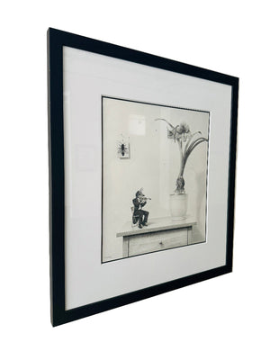 Framed black and white drawing on a wall