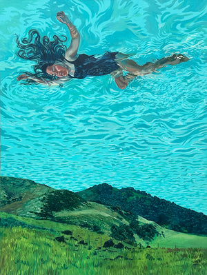 Woman floating on water with a landscape in the background