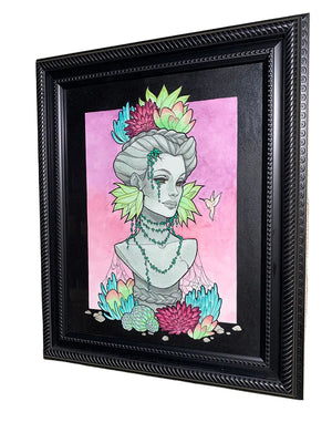 Framed artwork of a stylized bust with floral elements on a pink background