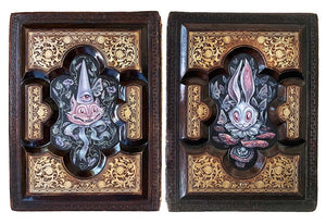 Two ornate wooden panels with intricate carvings of fantasy creatures.