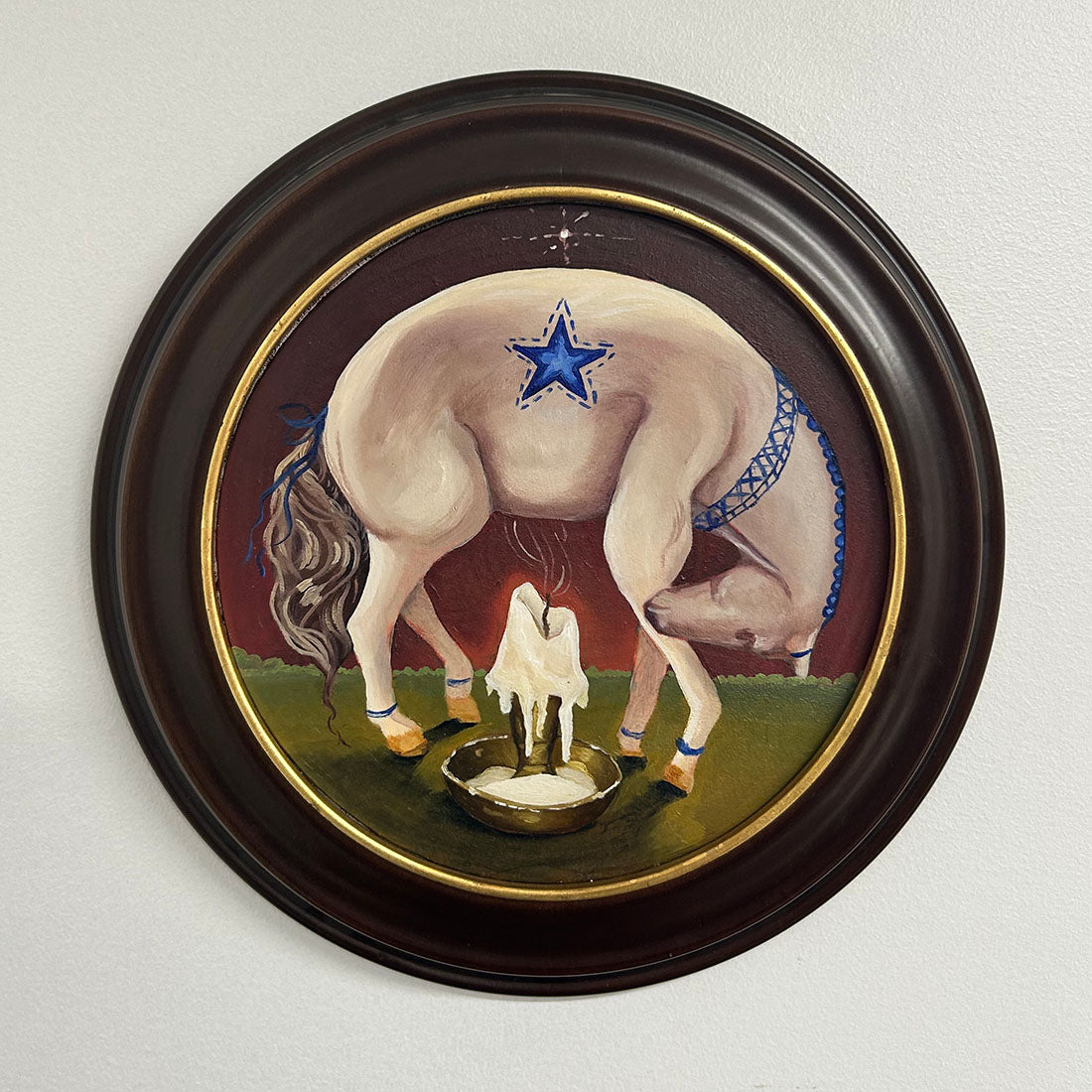 Painting of a horse with a star on its back, standing over a cauldron with a candle inside.
