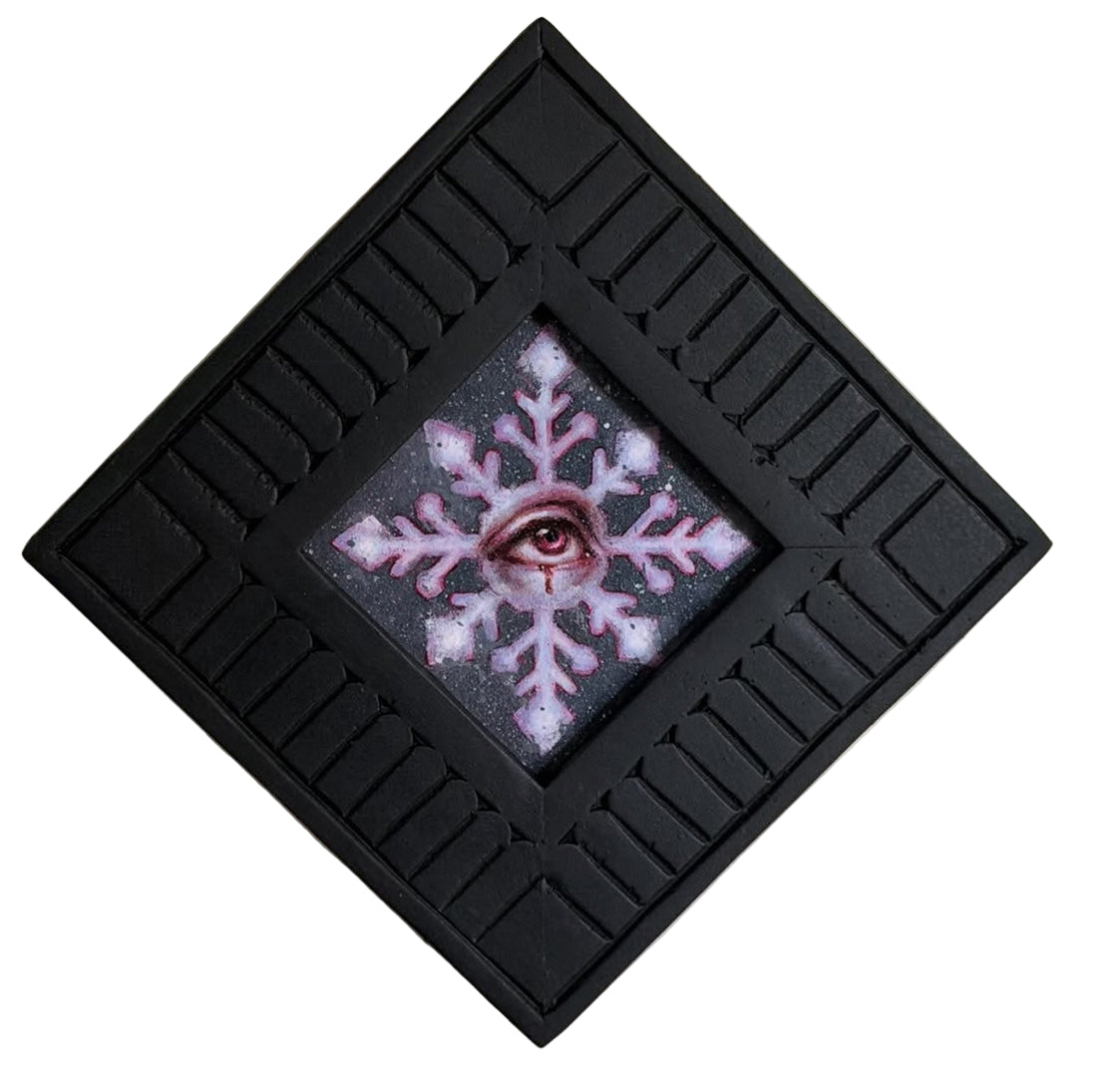 Painting with a pink snowflake design and eye in a black frame on a white background