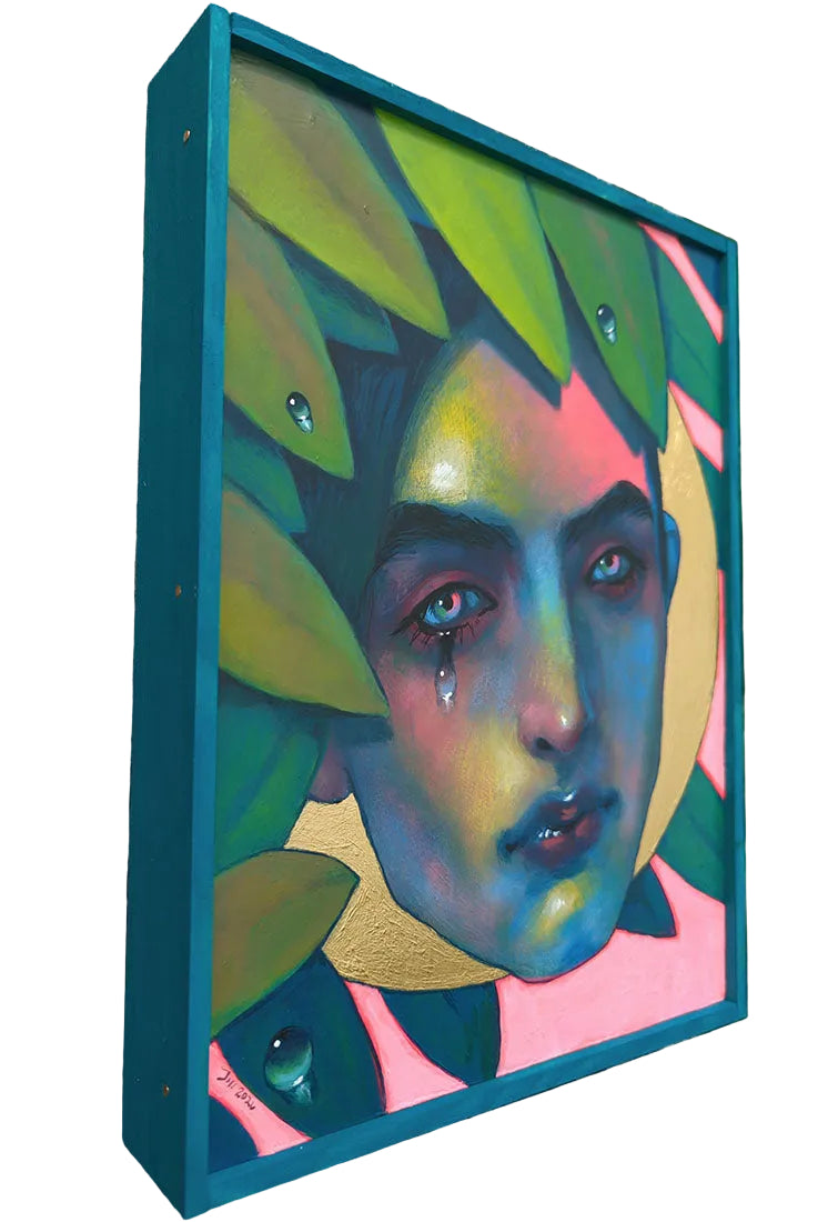 Colorful abstract painting of a face with leaves on a wooden surface