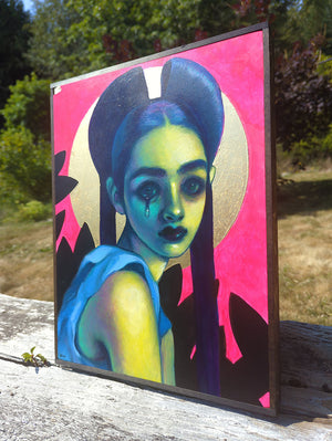 A framed portrait painting of a stylized woman with blue hair, a gold halo, and a bright pink background, leaning outdoors on a weathered wooden surface with trees behind it.