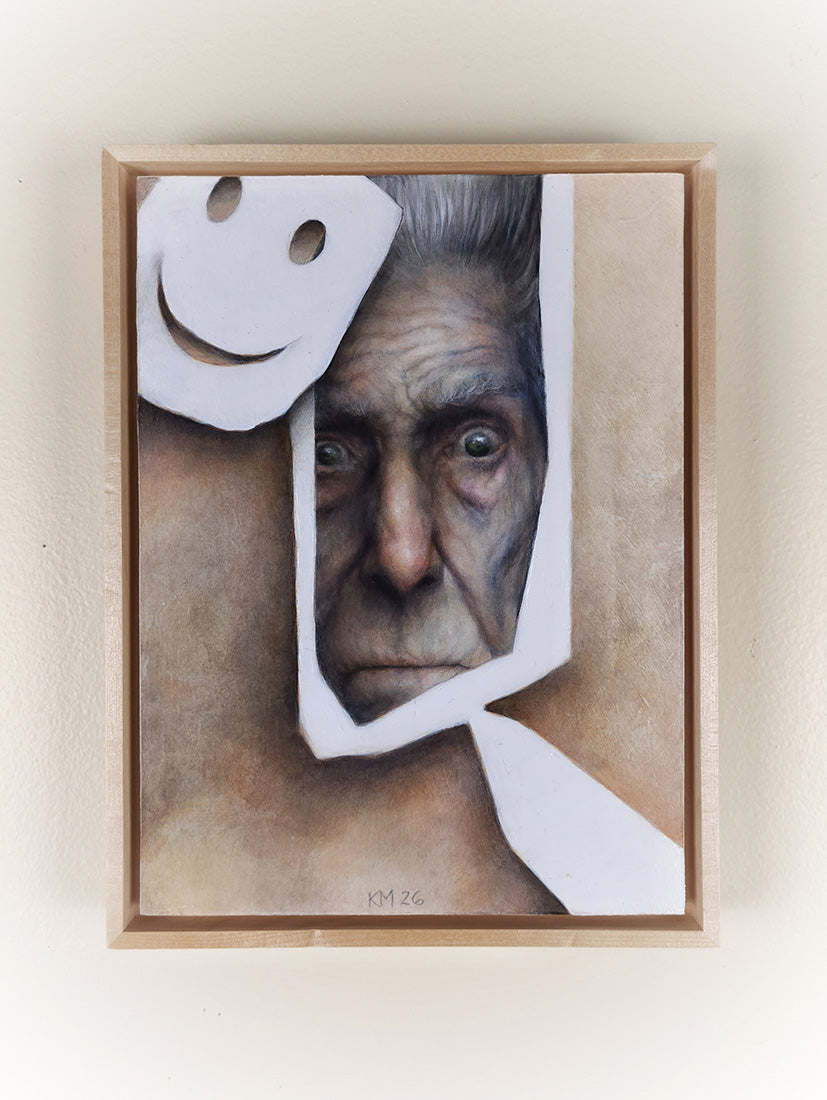 Framed artwork of a man's face with cut-out white shapes on a beige background