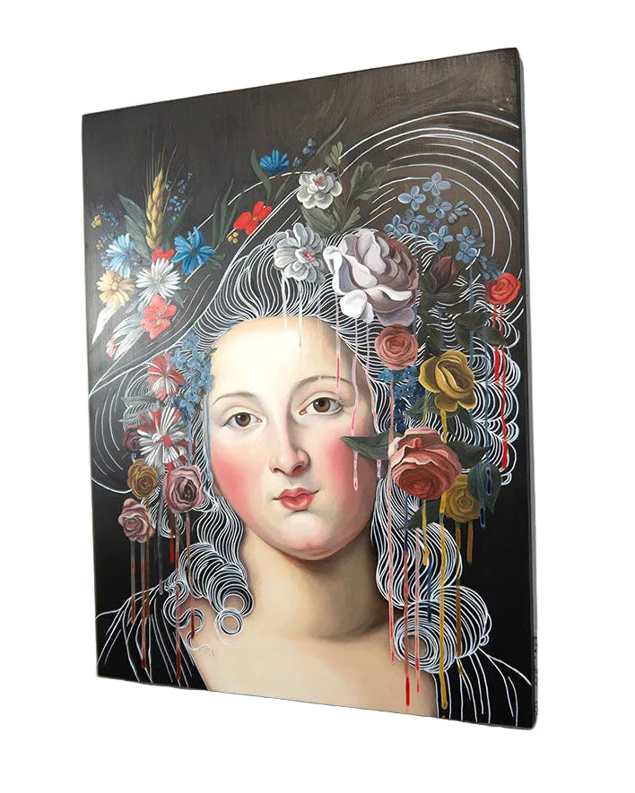 Artistic depiction of a woman's face with floral and decorative elements on a white wall.